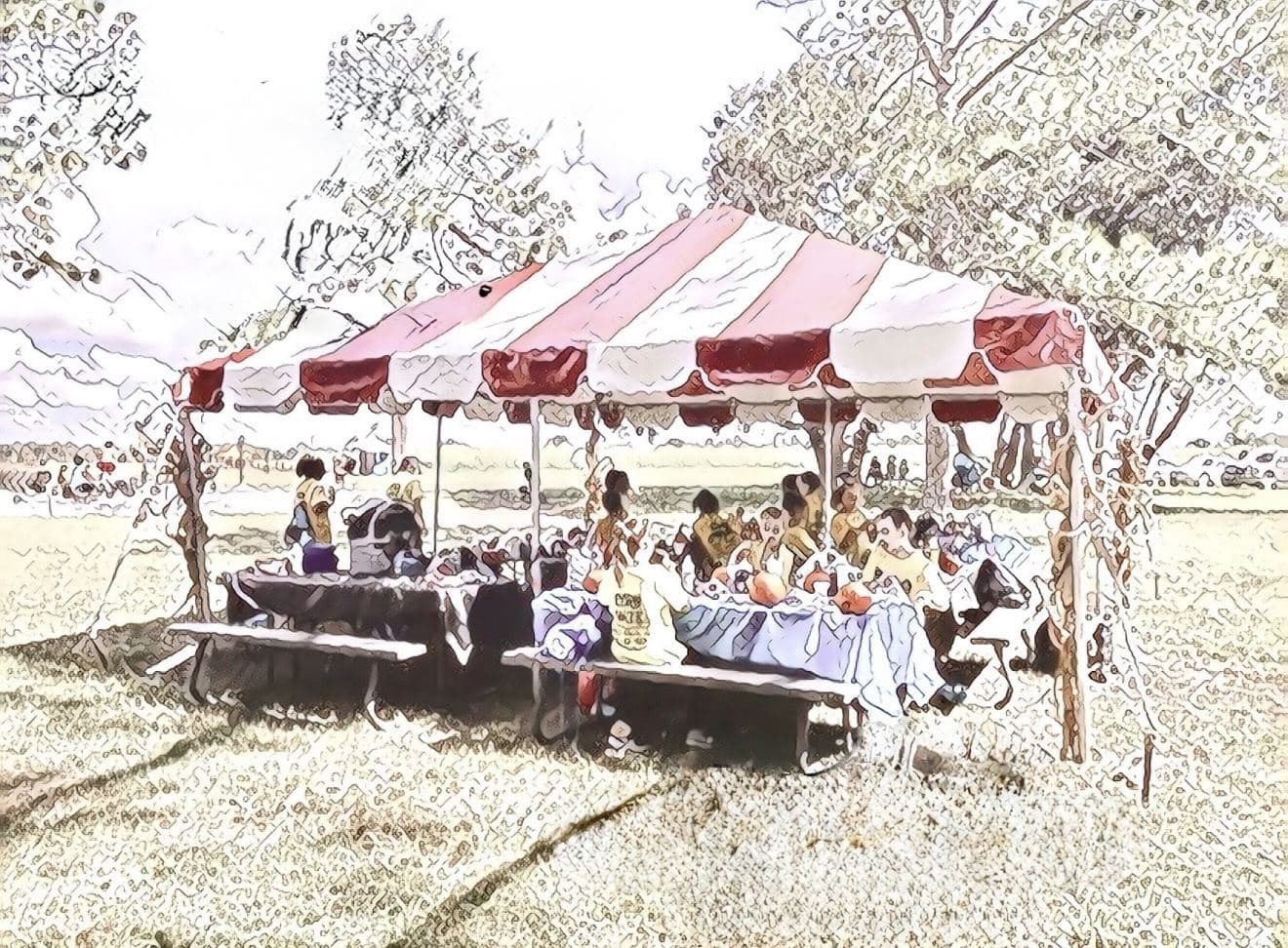 The striped party tent with picnic tables at Partin Ranch